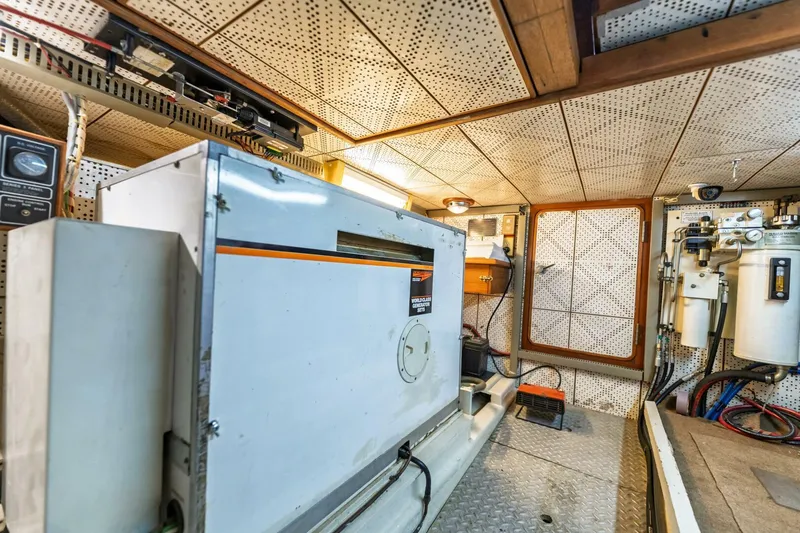 Slide: The Image of Engine room of 1992 DeFever 49 Pilothouse with generator and equipment. - 28