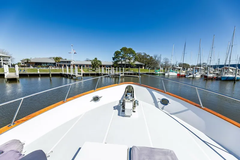 Slide: The Image of Bow view of 1992 DeFever 49 Pilothouse yacht docked at marina. - 30