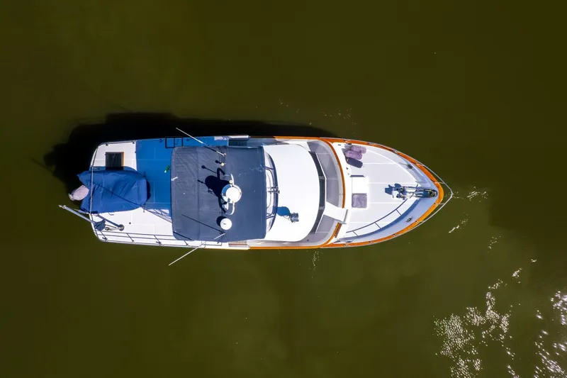 Slide: The Image of Overhead view of 1992 DeFever 49 Pilothouse boat on calm water. - 38