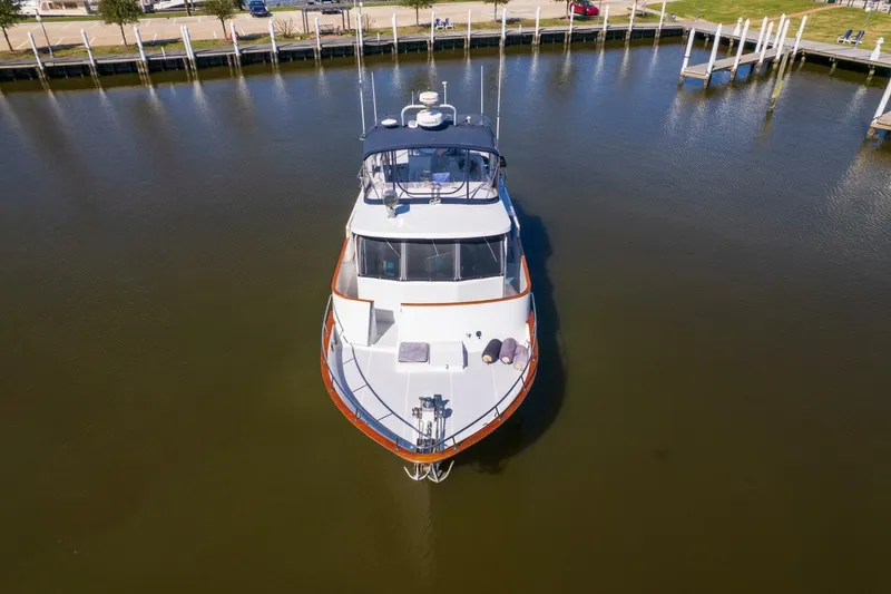 Slide: The Image of 1992 DeFever 49 Pilothouse yacht docked in calm marina waters. - 44