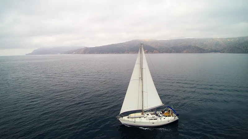 Slide: The Image of Sailing yacht Jeanneau Sun Odyssey 45.2, 2002, cruising on open sea with distant coastline. - 13