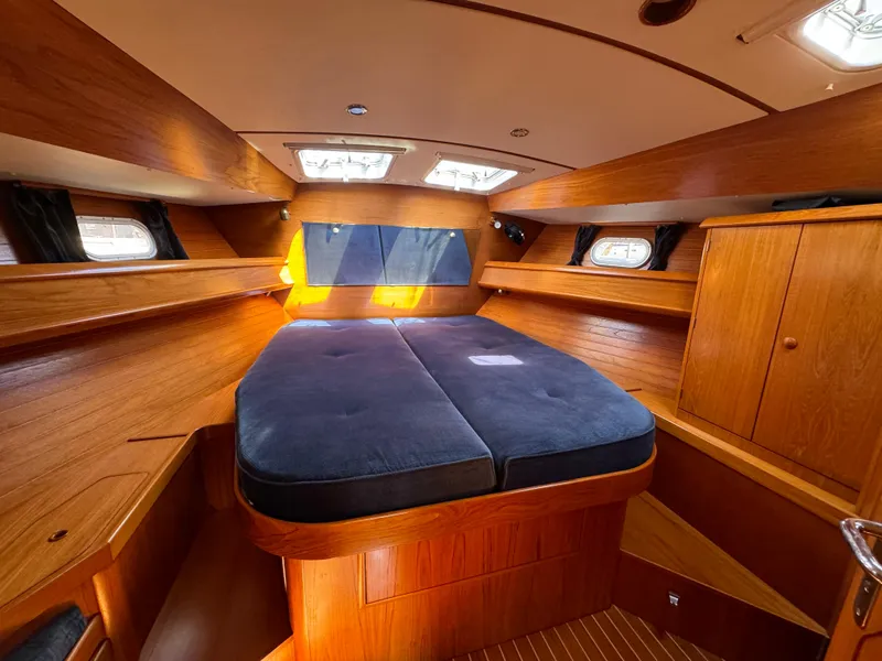 Slide: The Image of Luxurious cabin interior of 2002 Jeanneau Sun Odyssey 45.2 sailboat with wood finish. - 15