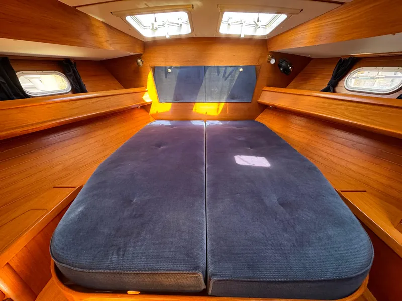 Slide: The Image of Cozy cabin interior of 2002 Jeanneau Sun Odyssey 45.2 sailboat with blue bedding. - 16