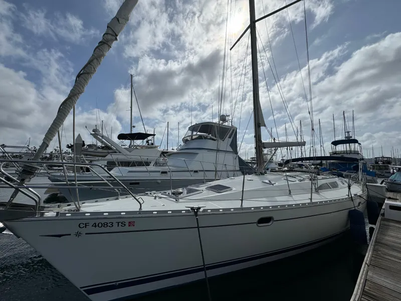 Slide: The Image of 2002 Jeanneau Sun Odyssey 45.2 sailboat docked at marina under cloudy sky. - 2