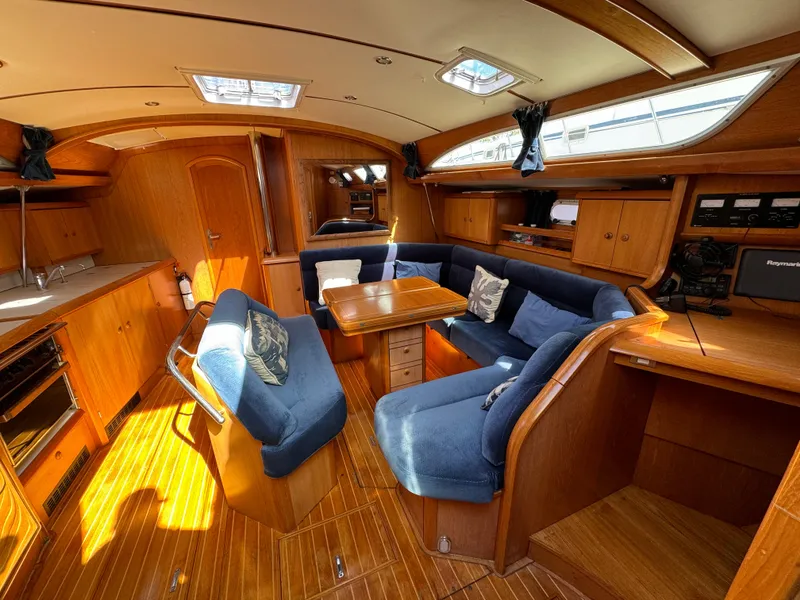Slide: The Image of Interior of 2002 Jeanneau Sun Odyssey 45.2 yacht with blue seating and wooden finishes. - 23