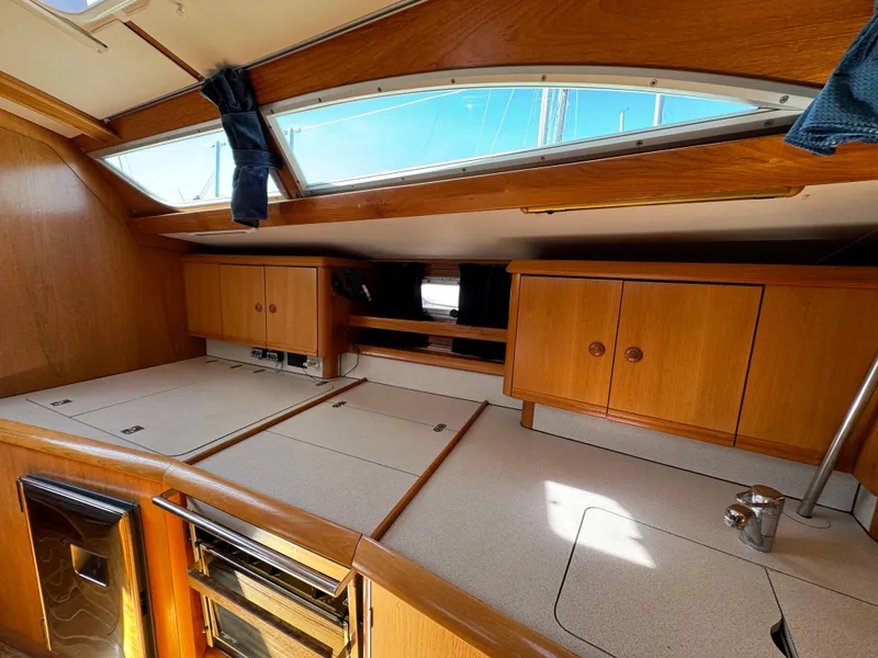 Slide: The Image of Interior of 2002 Jeanneau Sun Odyssey 45.2 sailboat with wooden cabinetry and skylights. - 28