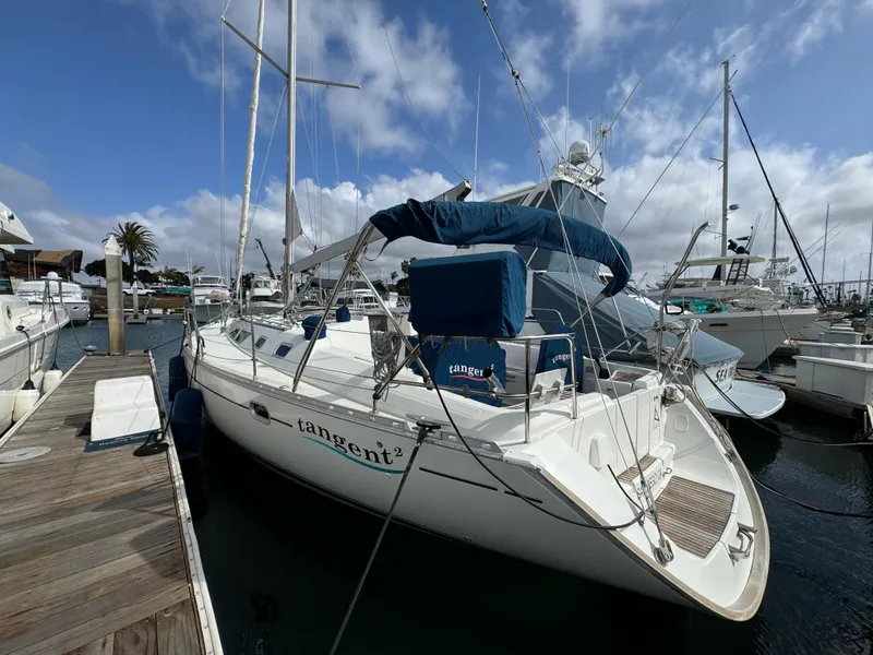 Slide: The Image of 2002 Jeanneau Sun Odyssey 45.2 sailboat docked at marina under cloudy sky. - 3