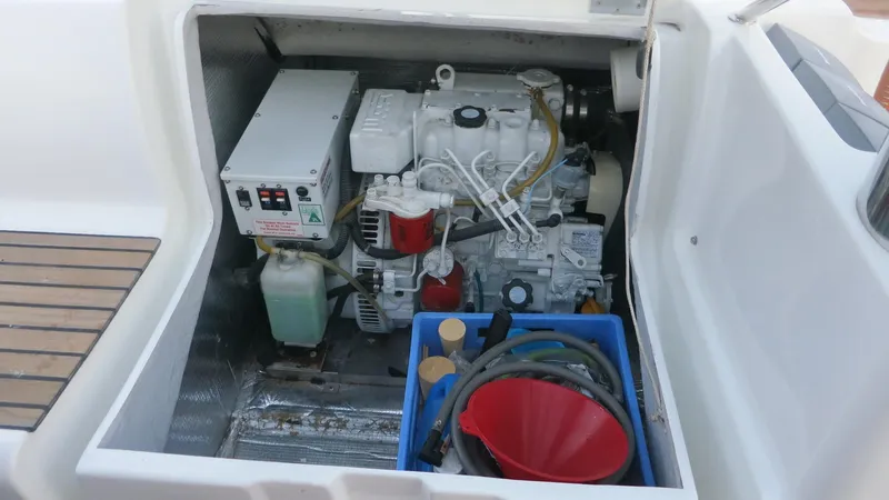Slide: The Image of Engine compartment of 2002 Jeanneau Sun Odyssey 45.2 sailboat, showing engine and maintenance tools. - 30