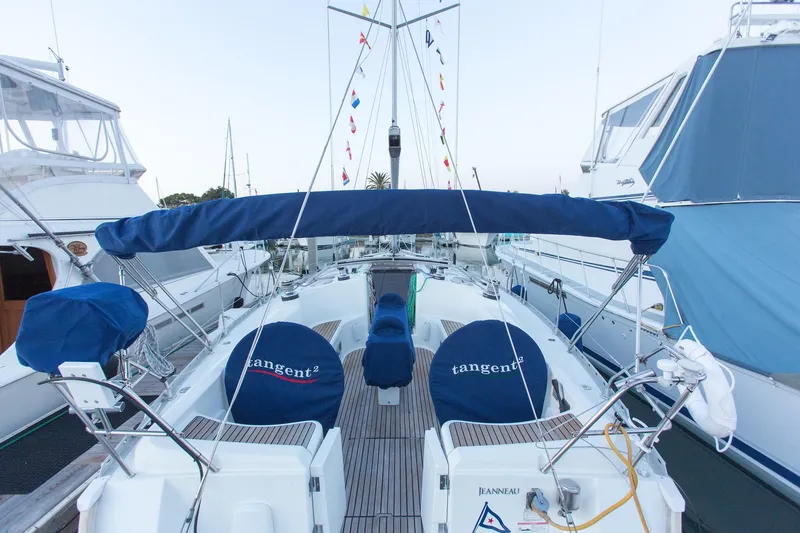 Slide: The Image of Jeanneau Sun Odyssey 45.2 sailboat, 2002 model, docked with blue covers and flags. - 5