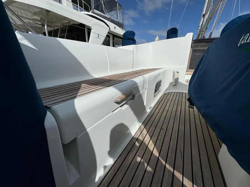 Slide: The Image of Jeanneau Sun Odyssey 45.2 yacht deck, 2002 model, featuring teak flooring and white seating. - 8