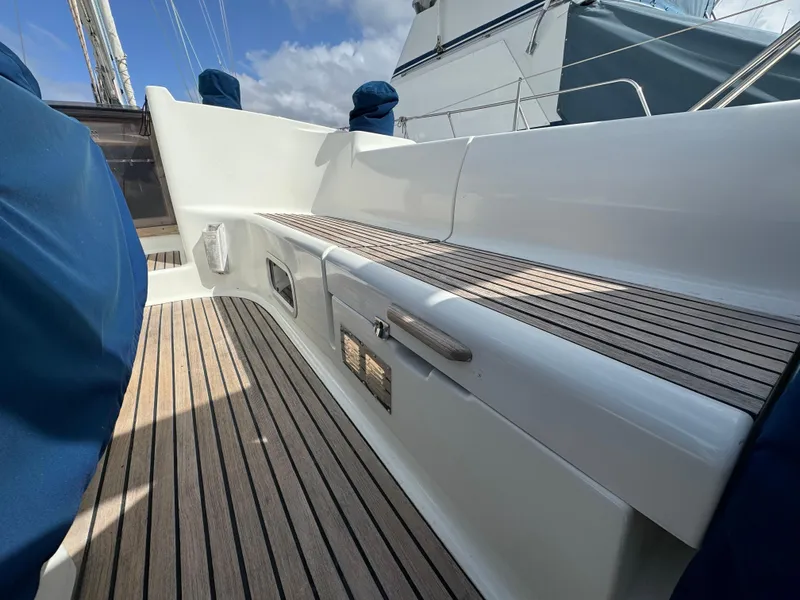 Slide: The Image of Jeanneau Sun Odyssey 45.2 yacht deck, 2002 model, featuring sleek wooden finish and modern design. - 9