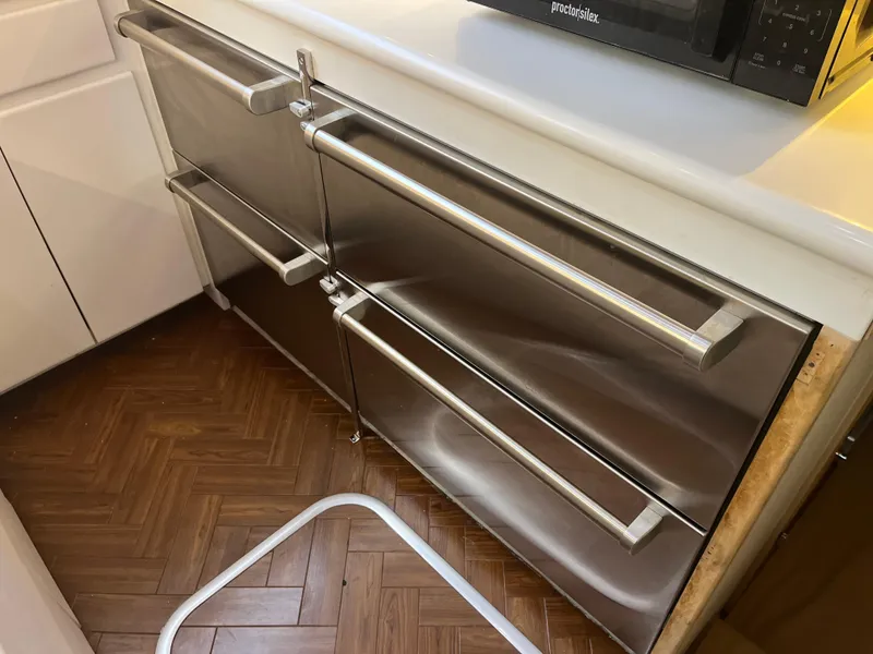 Slide: The Image of Stainless steel drawers in a 1995 Hatteras 45 Convertible yacht kitchen. - 11