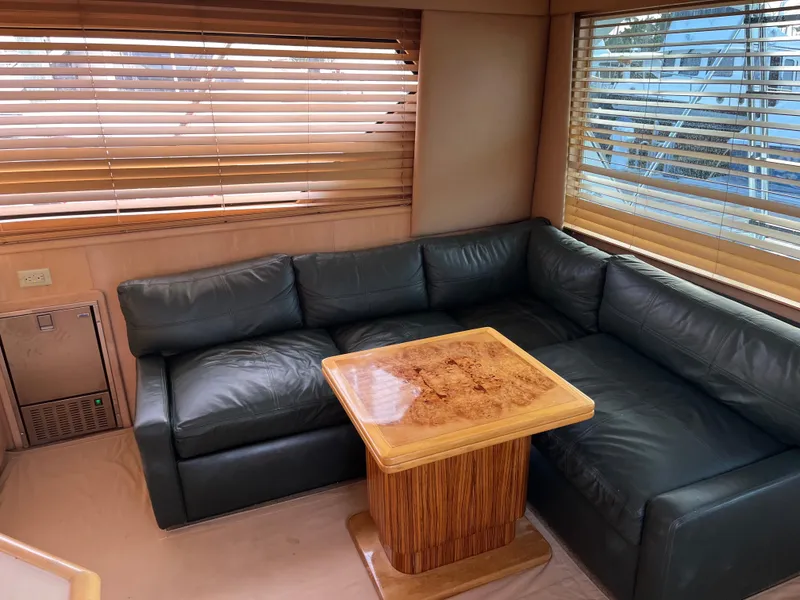 Slide: The Image of Luxurious interior of 1995 Hatteras 45 Convertible yacht with leather sofa and wooden table. - 13