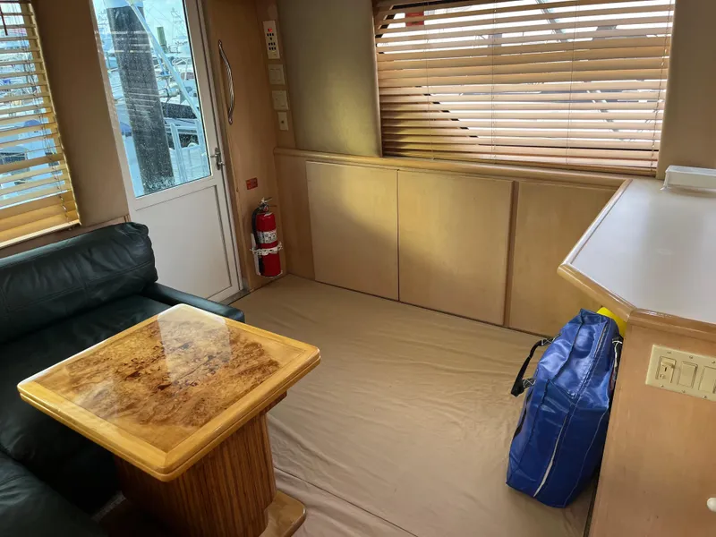 Slide: The Image of Interior of 1995 Hatteras 45 Convertible yacht with wooden table and leather seating. - 14