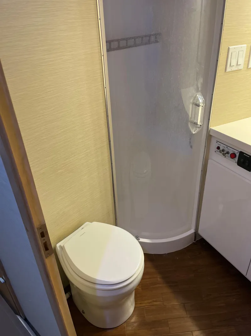 Slide: The Image of Bathroom interior of 1995 Hatteras 45 Convertible yacht with shower and toilet. - 16