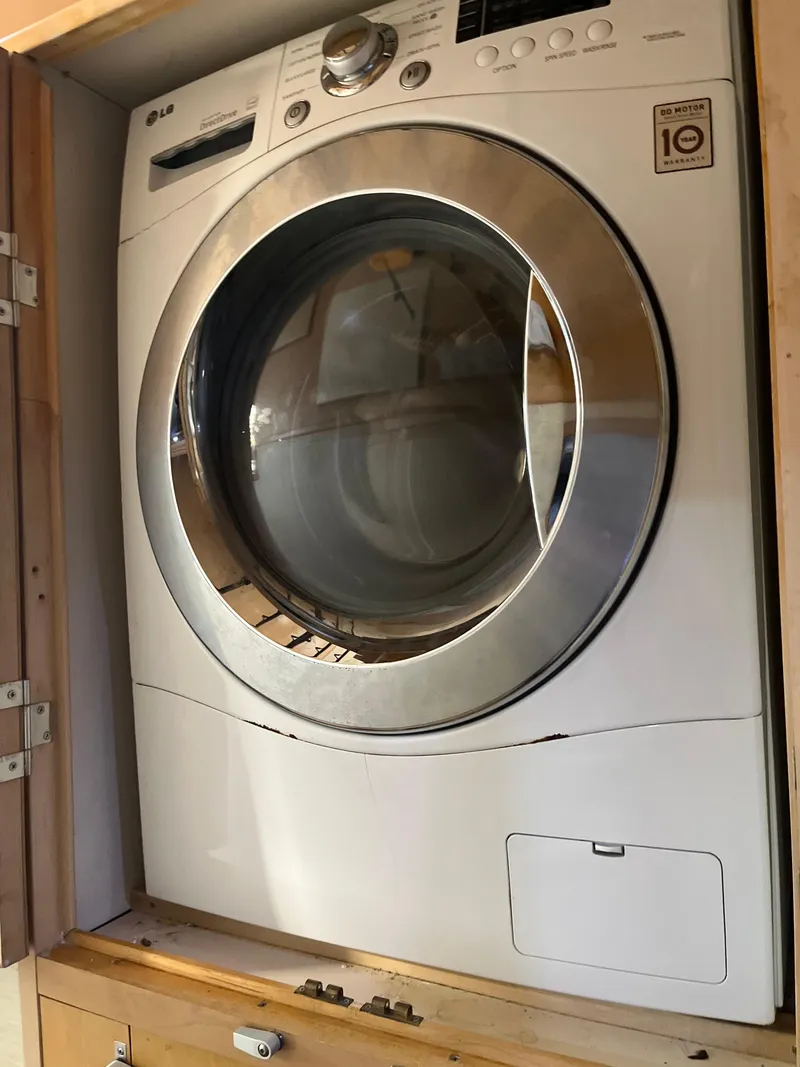 Slide: The Image of Front-loading LG washing machine in a wooden cabinet. - 18
