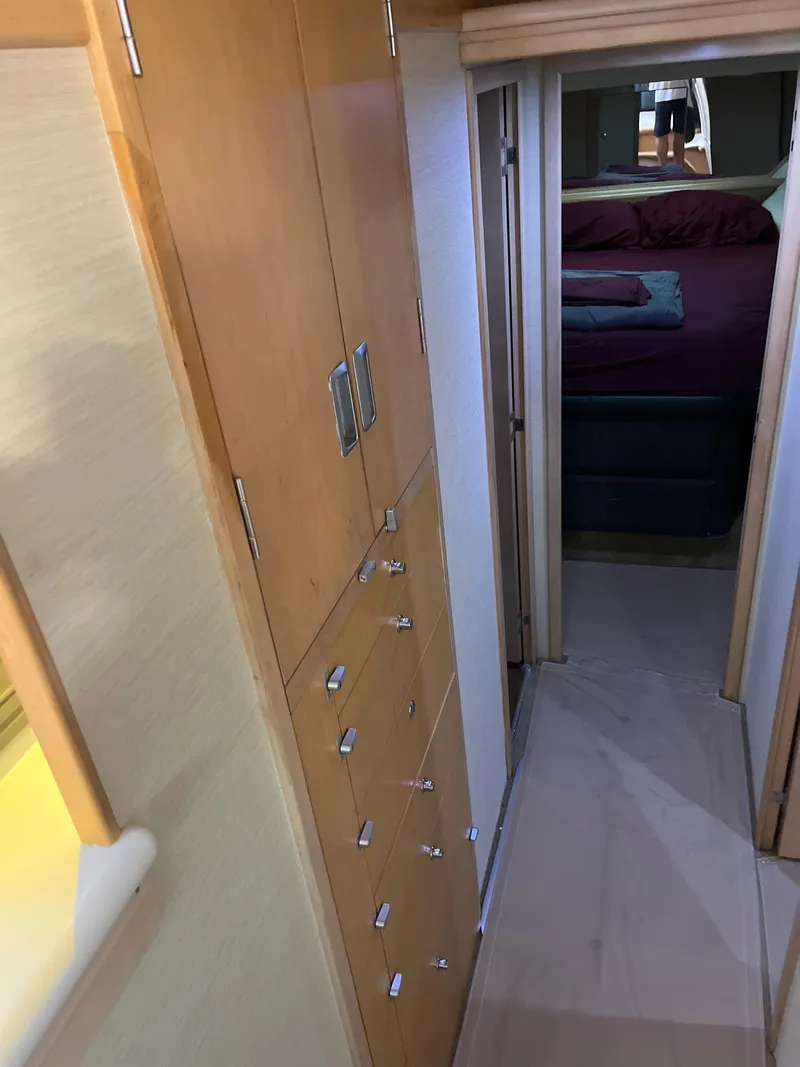 Slide: The Image of Interior hallway of 1995 Hatteras 45 Convertible yacht with wooden cabinetry. - 19