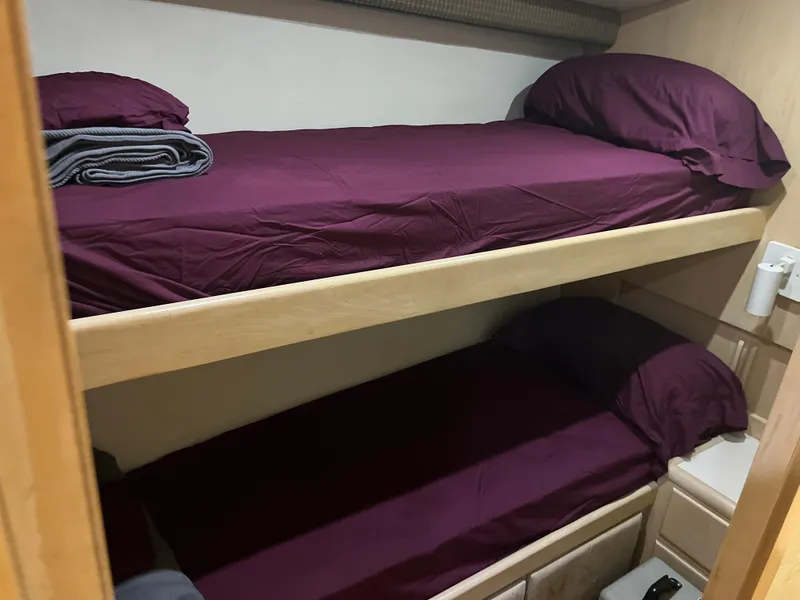 Slide: The Image of Bunk beds with purple bedding in a 1995 Hatteras 45 Convertible yacht cabin. - 20