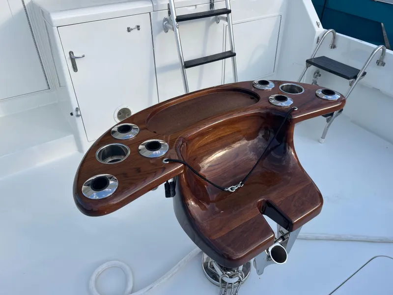 Slide: The Image of Cockpit of 1995 Hatteras 45 Convertible yacht with wooden fighting chair and rod holders. - 6