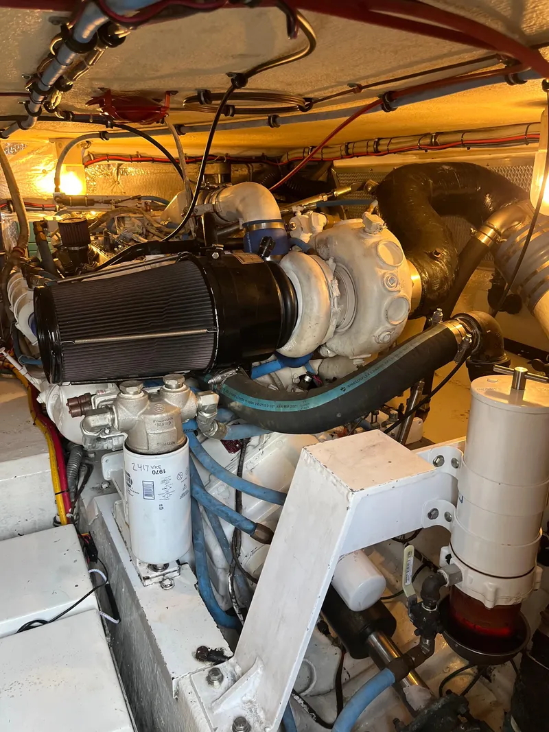 Slide: The Image of Engine room of 1995 Hatteras 45 Convertible yacht, showcasing mechanical components and systems. - 8