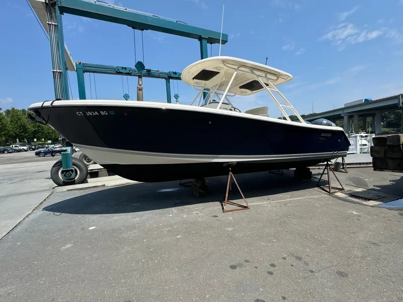 Slide: The Image of 2014 Pursuit S 280 Sport boat on stands at a marina. - 0