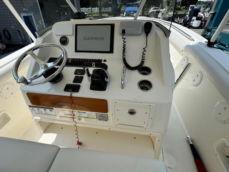 Slide: The Image of 2014 Pursuit S 280 Sport boat dashboard with Garmin navigation system and controls. - 2