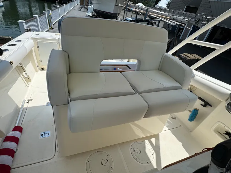 Slide: The Image of 2014 Pursuit S 280 Sport boat with white cushioned seating on deck. - 3