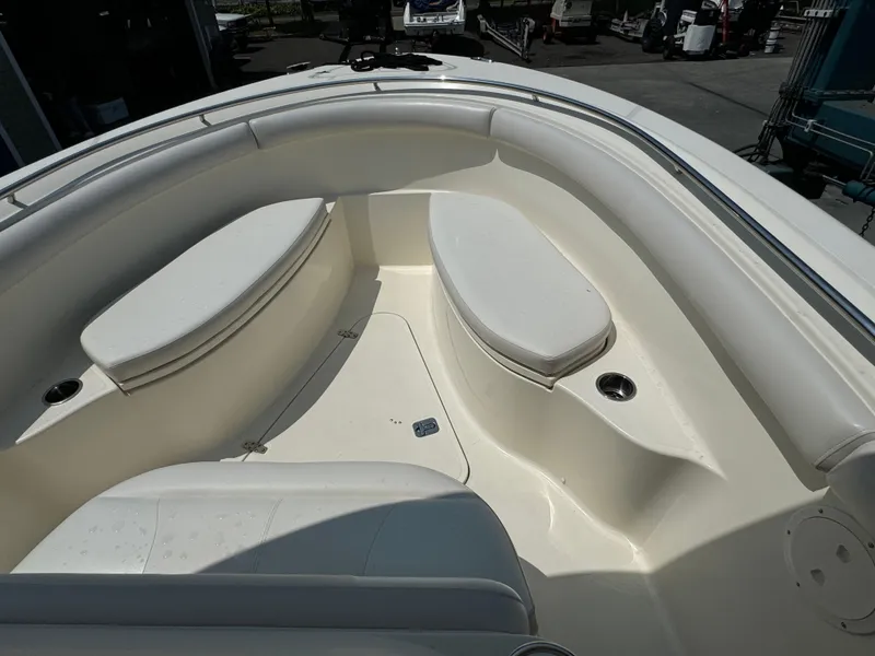 Slide: The Image of 2014 Pursuit S 280 Sport boat interior with cushioned seating and cup holders. - 4