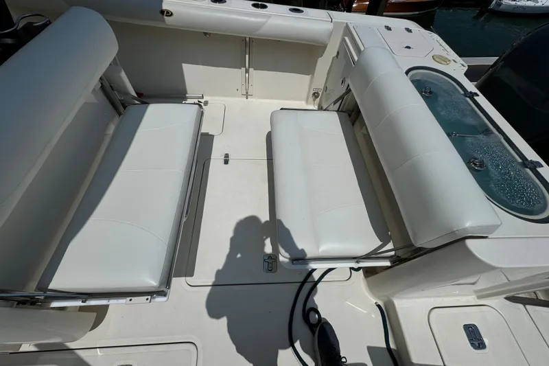 Slide: The Image of 2014 Pursuit S 280 Sport boat interior with white seating and storage compartments. - 5