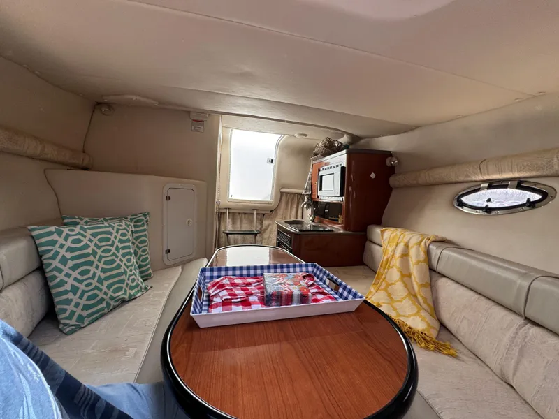 Slide: The Image of Interior of 2003 Crownline 262 CR boat with cozy seating and kitchenette. - 15