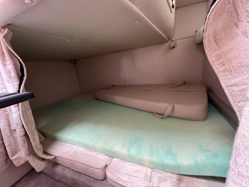 Slide: The Image of 2003 Crownline 262 CR cabin interior with cushions and curtains. - 20