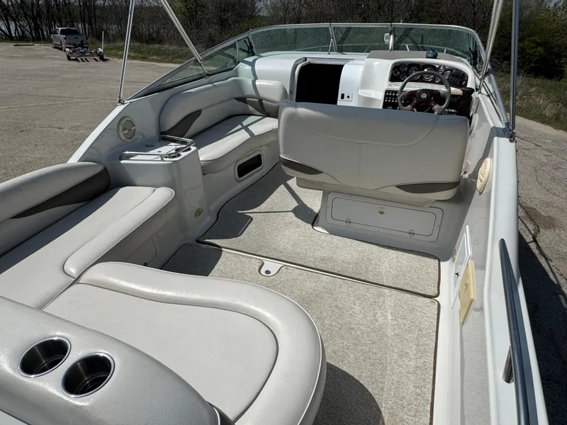 Slide: The Image of 2003 Crownline 262 CR boat interior with seating and steering console. - 8