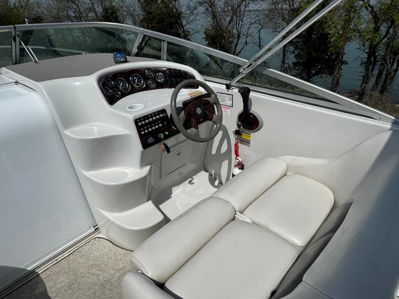 Slide: The Image of 2003 Crownline 262 CR boat cockpit with steering wheel and control panel. - 9