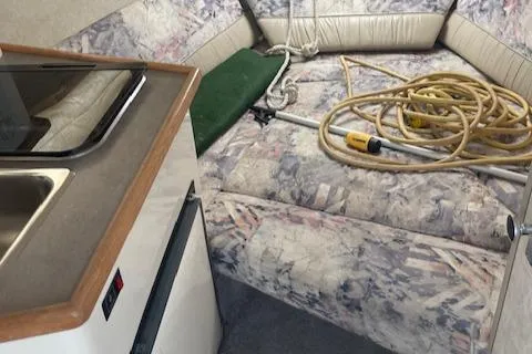 Slide: The Image of 1997 Bayliner 2355 SJ Ciera cabin interior with kitchenette and seating area. - 5