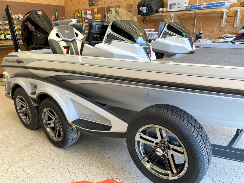 Slide: The Image of 2023 Ranger Z520R 55th Anniversary Limited Edition boat in showroom, featuring sleek design and triple axle. - 16