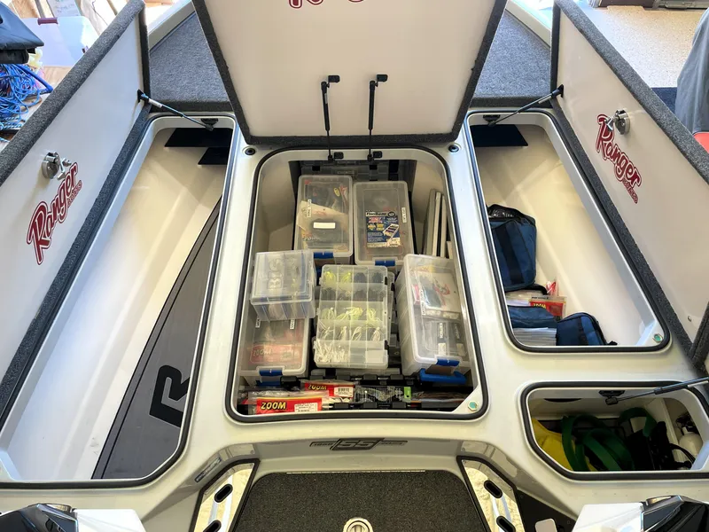 Slide: The Image of 2023 Ranger Z520R 55th Anniversary boat storage compartments filled with fishing gear and tackle boxes. - 27