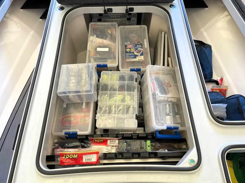 Slide: The Image of Storage compartment of 2023 Ranger Z520R boat with organized fishing gear and tackle boxes. - 30