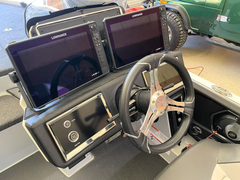 Slide: The Image of 2023 Ranger Z520R 55th Anniversary boat dashboard with dual Lowrance displays and steering wheel. - 37