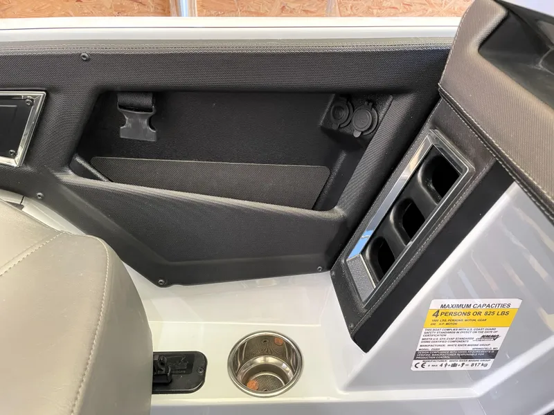 Slide: The Image of Interior of 2023 Ranger Z520R 55th Anniversary boat, featuring cup holder and storage compartments. - 44