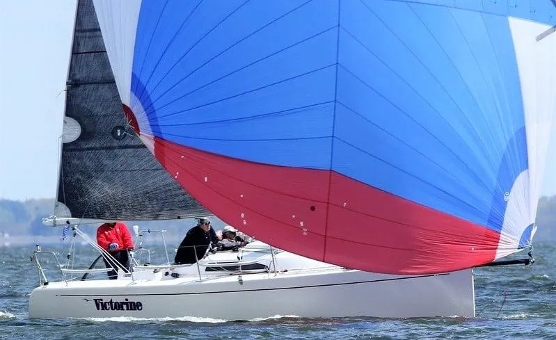 Slide: The Image of Sailboat Columbia 32 (2007) with colorful spinnaker sailing on open water. - 0