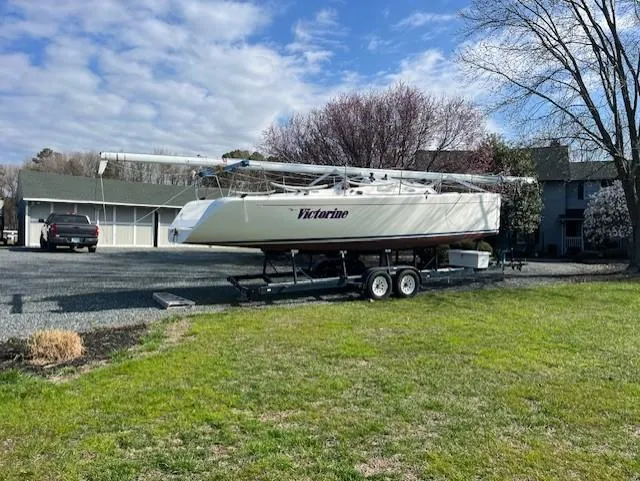Slide: The Image of Sailboat on trailer, Columbia 32 model, 2007, parked on gravel driveway. - 10
