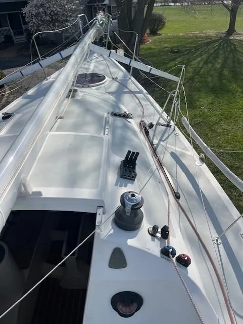 Slide: The Image of 2007 Columbia 32 sailboat deck with rigging and winch, docked on grassy area. - 11