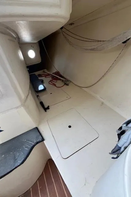 Slide: The Image of Interior of 2007 Columbia 32 sailboat, featuring storage compartments and seating. - 17