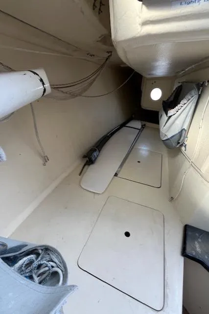 Slide: The Image of Interior of 2007 Columbia 32 sailboat, featuring storage compartments and nautical equipment. - 18