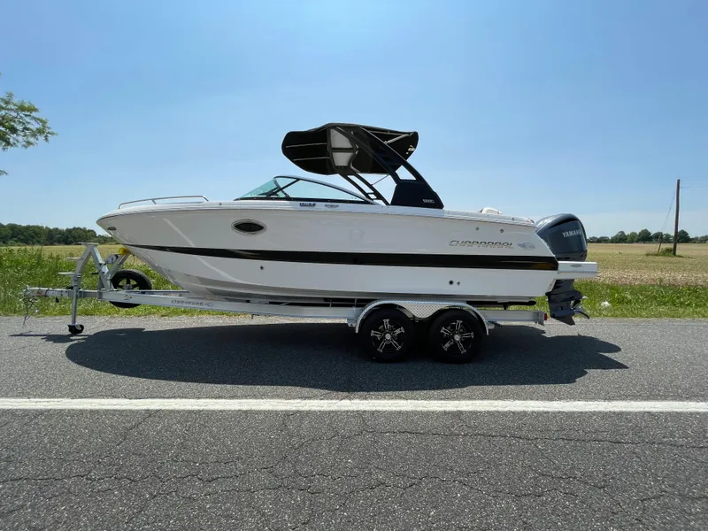 Slide: The Image of 2024 Chaparral 250 OSX boat on trailer, side view, outdoors, sunny day. - 0