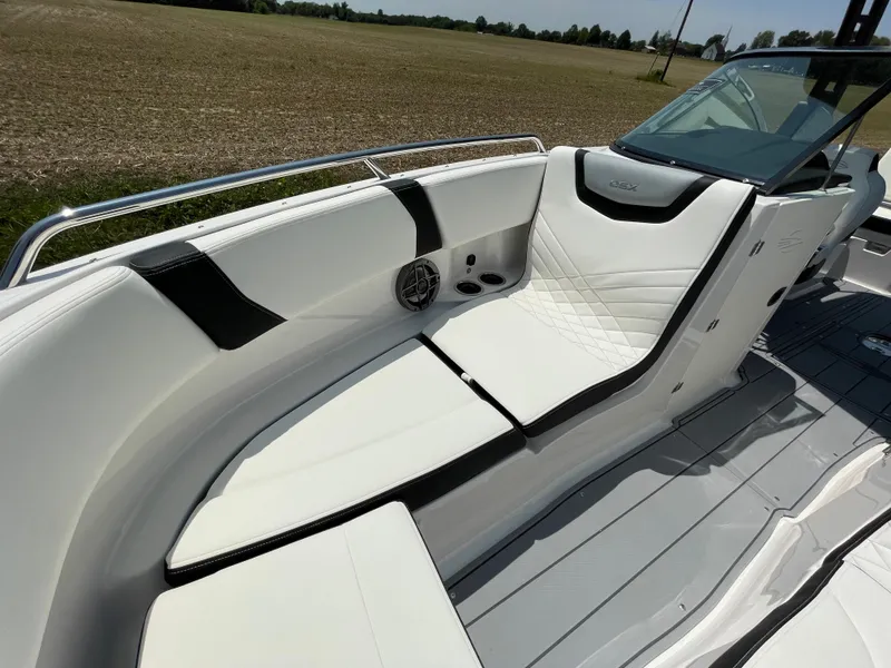 Slide: The Image of 2024 Chaparral 250 OSX boat interior with white seating and sleek design. - 10