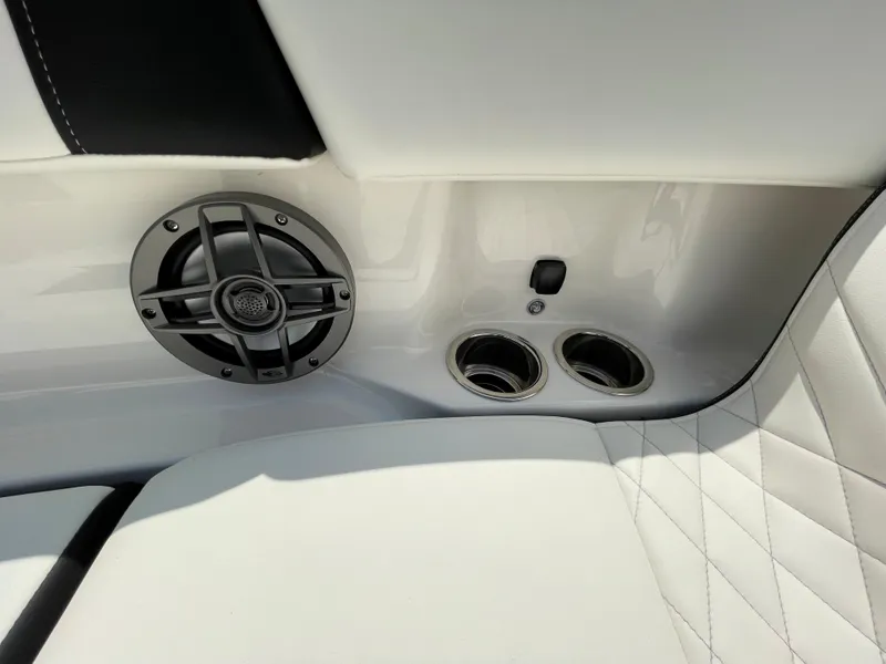 Slide: The Image of 2024 Chaparral 250 OSX interior with speaker and cup holders. - 11