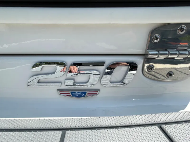 Slide: The Image of 2024 Chaparral 250 OSX boat emblem with chrome finish and textured surface. - 4