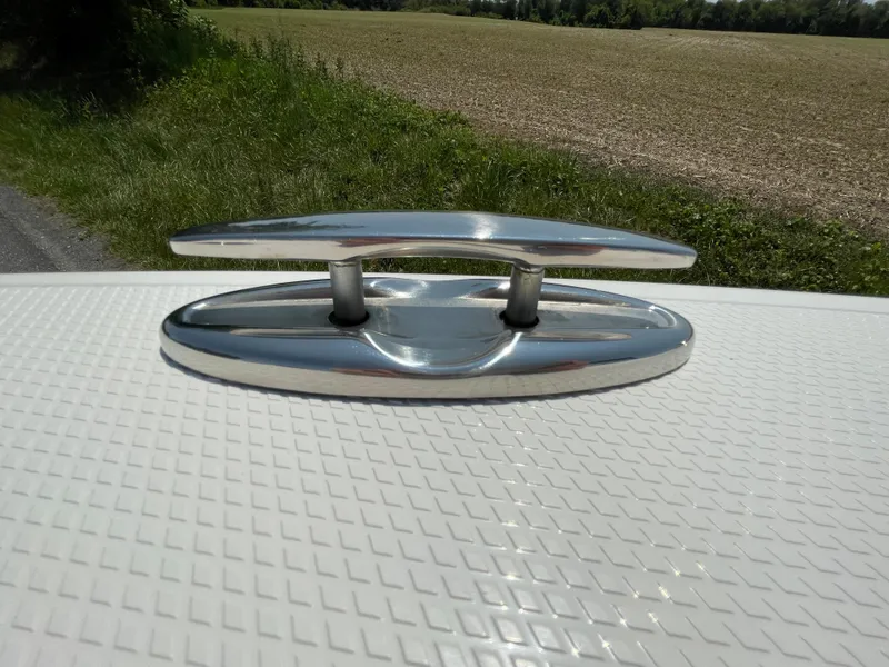 Slide: The Image of 2024 Chaparral 250 OSX boat cleat on textured deck surface. - 7