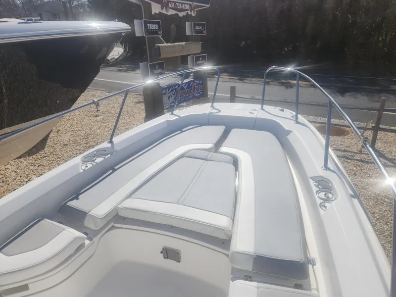 Slide: The Image of 2015 Boston Whaler 240 Dauntless boat with cushioned seating and stainless steel railings. - 13